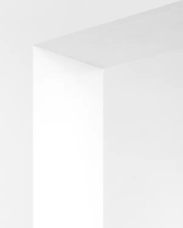 A white plastered corner with a deep shadow line